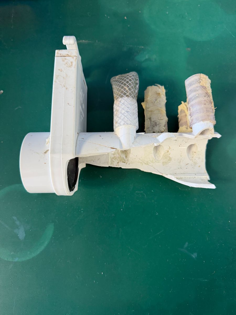 Close-up of cracked hot tub plumbing fittings from freeze damage repaired by Mirage Spa